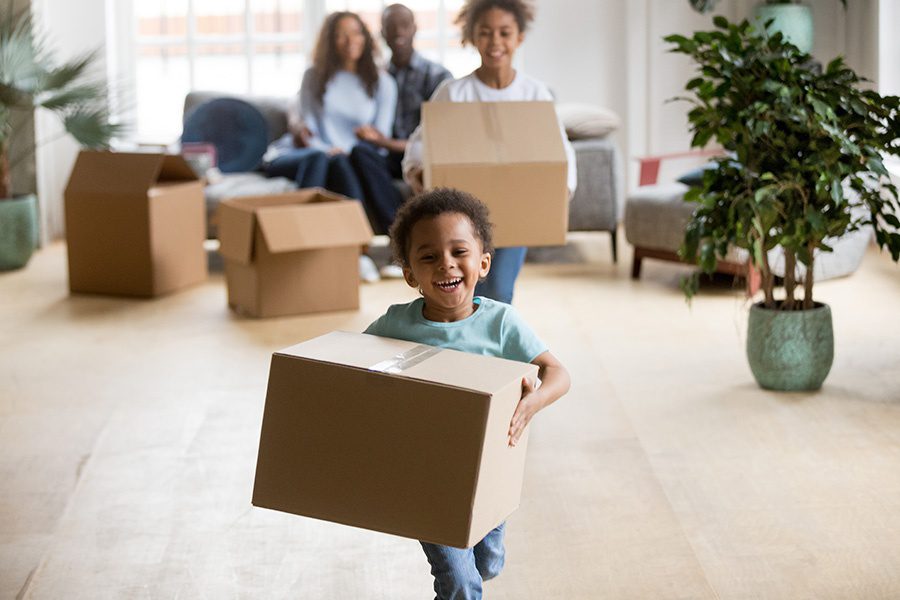 Employee Benefits - Happy Children Enjoying Moving Day Running and Carrying Boxes in Their New Home